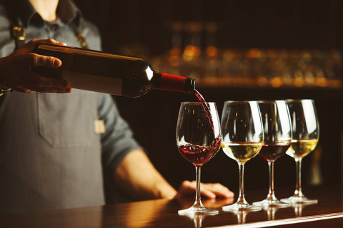 bartender pouring 4 glasses of wine from wine bottle - How Many Glasses Of Wine Are In A Bottle? - The Wine Cellar Group