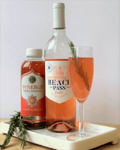 guava rose cocktail garnished with rosemary sprig