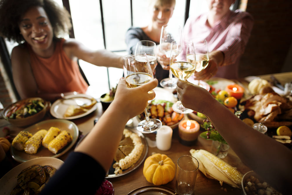 people drinking holiday wine during meal
