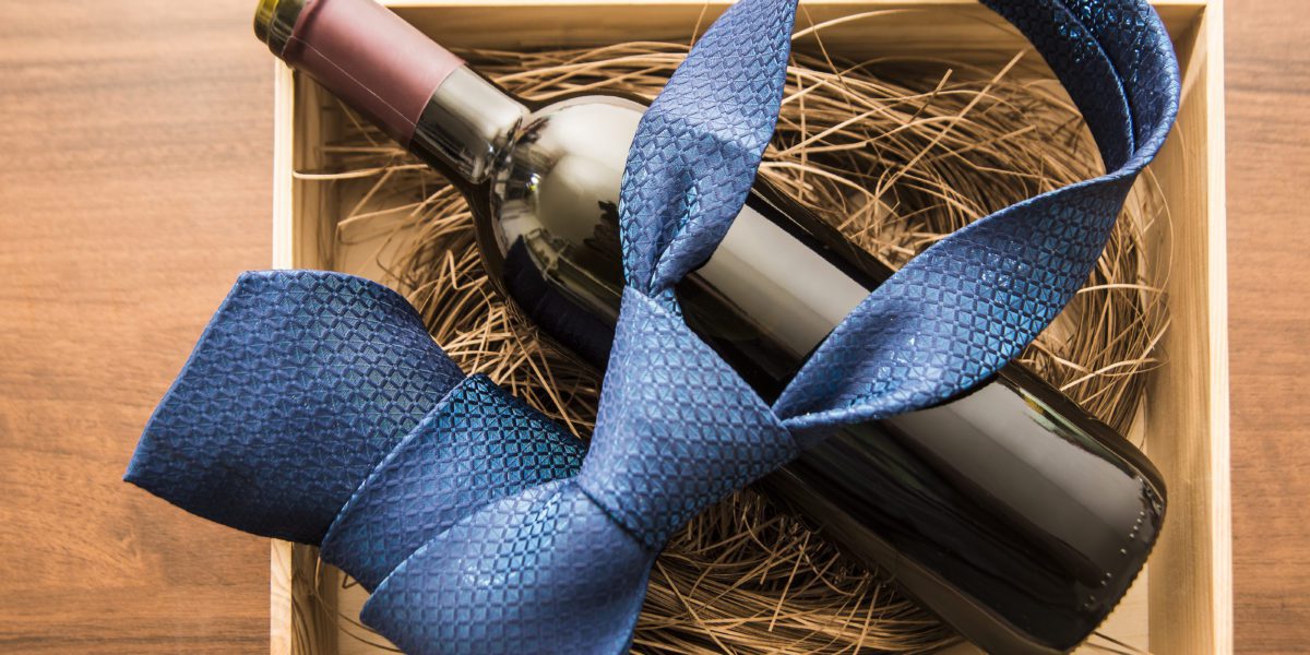 bottle of red wine with blue tie in box