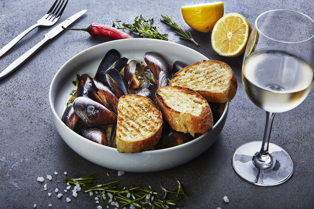 glass of white wine paired with mussels