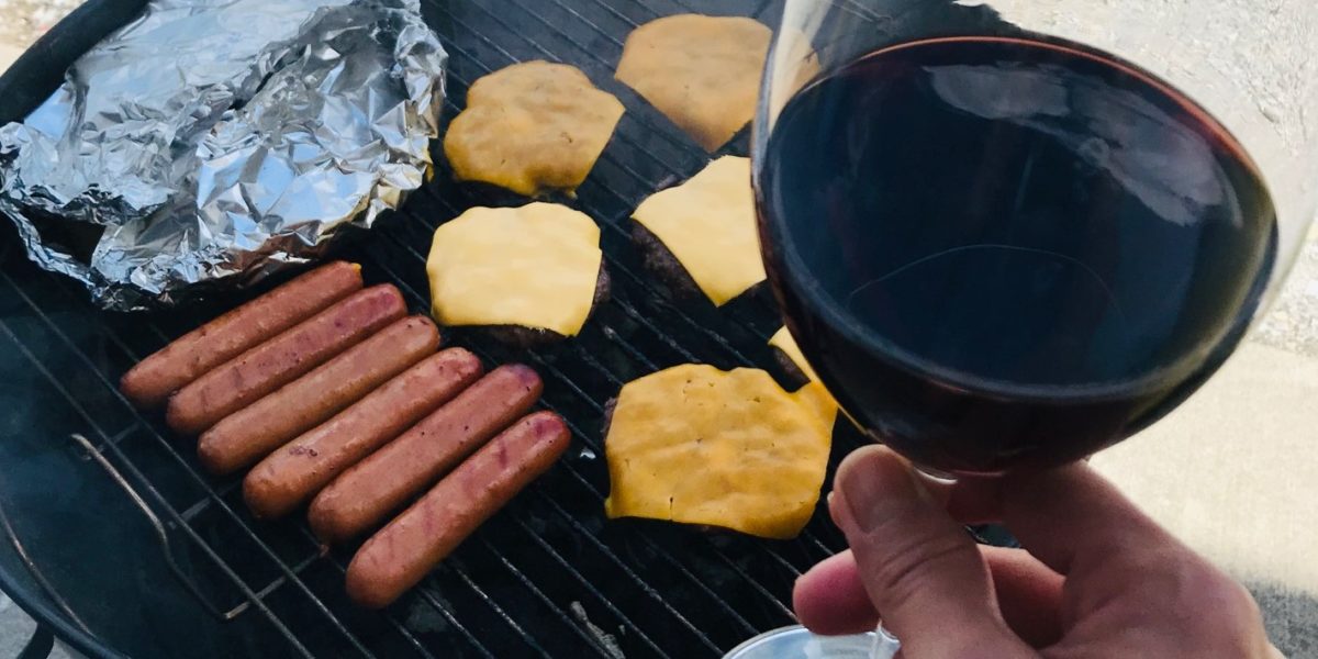 Glass of red wine and grill