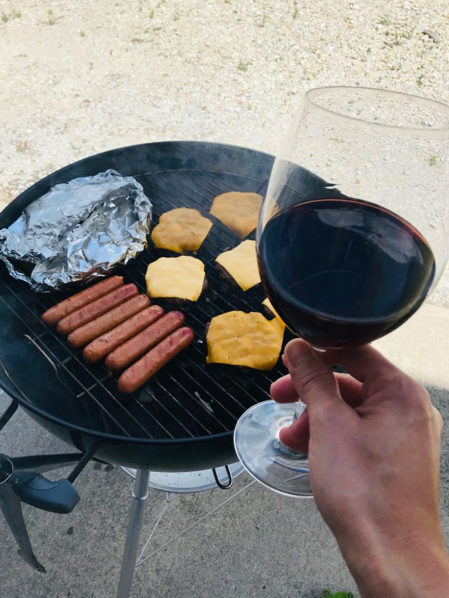 Glass of red wine and grill
