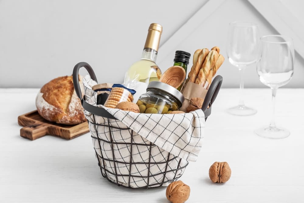 wine gift basket with white wine, olives, and bread