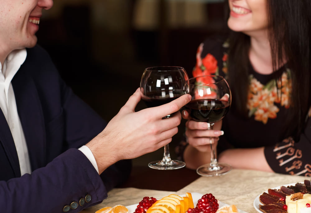 couple sharing romantic dinner with wine
