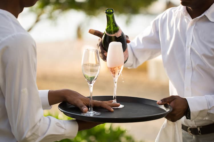 servers serving champagne at wedding