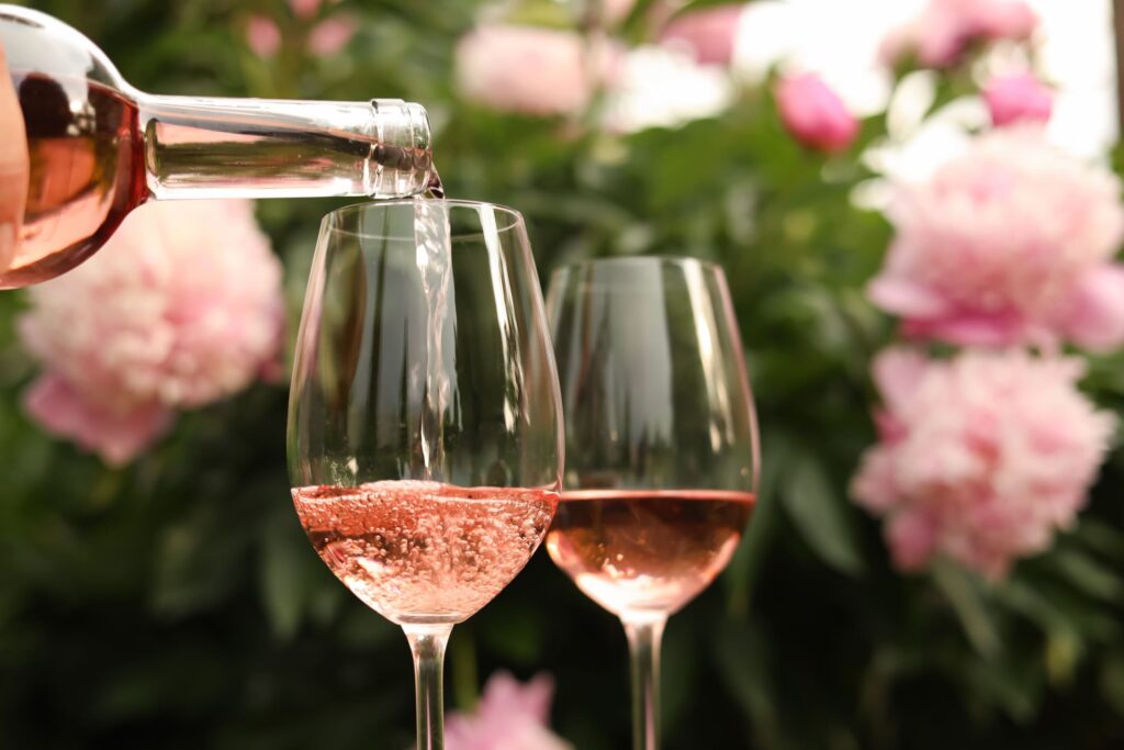 pouring vegan rose wine into two glasses
