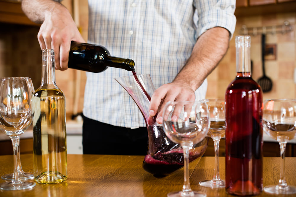 man decanting red wine